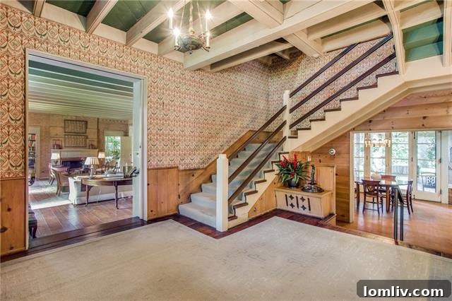 The elegant grand staircase inside the historic Williams House at 3805 McFarlin
