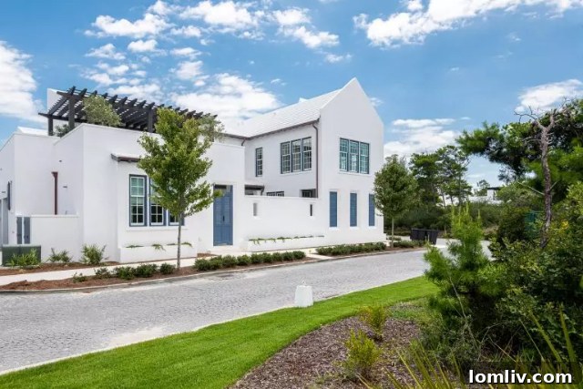 Idyllic street scene in Alys Beach, showcasing distinctive white architecture and lush greenery.