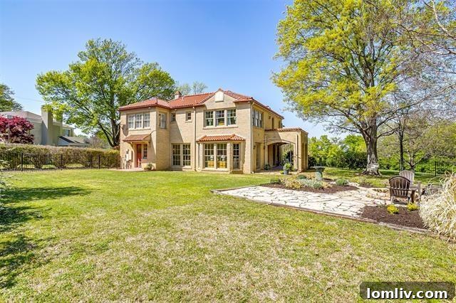 Idyllic backyard oasis featuring a covered patio, lush landscaping, and a fire pit, perfect for outdoor entertaining at 2200 Winton Terrace E.