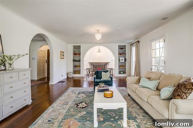 Airy and bright living area after renovation, highlighting the iconic Batchelder tile fireplace and updated decor at 2200 Winton Terrace E.