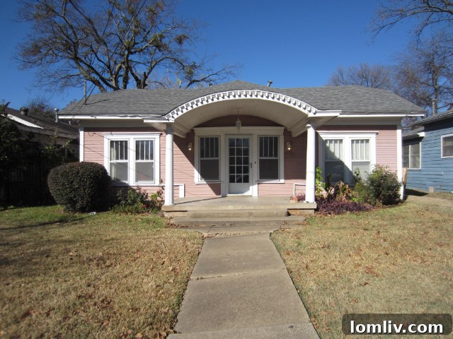 Tam Pham, owner of Steel Toe Stiletto Construction, standing in front of the restored 5307 Worth Street home.