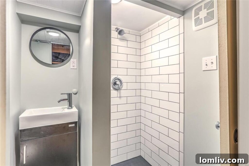 A clean, modern bathroom with Ikea-style fixtures and white tiles