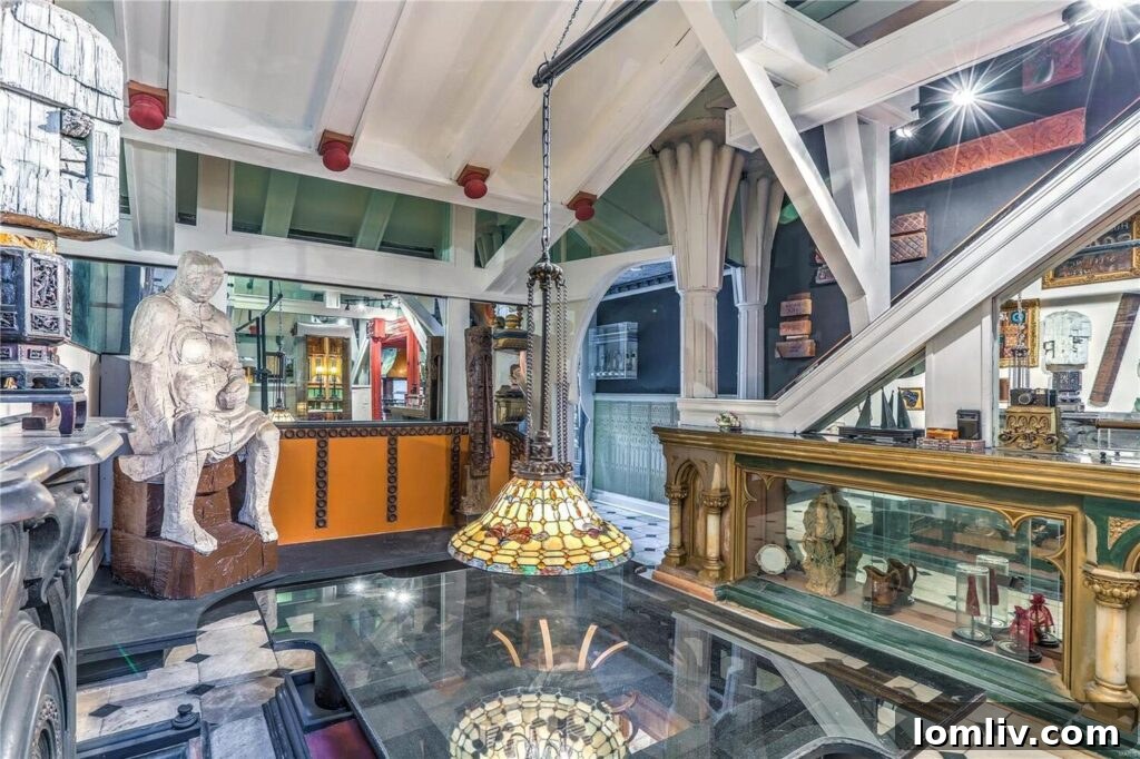 An interior balcony overlooking a vast, artistically decorated living space