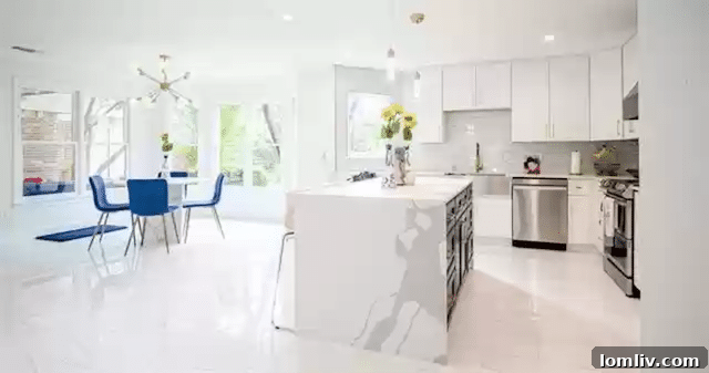 Uncover Lake Highlands: Unexpected Splurges and Smart Steals 5 Gourmet kitchen in Dallas home featuring a stunning waterfall quartz island, custom cabinetry, and modern appliances