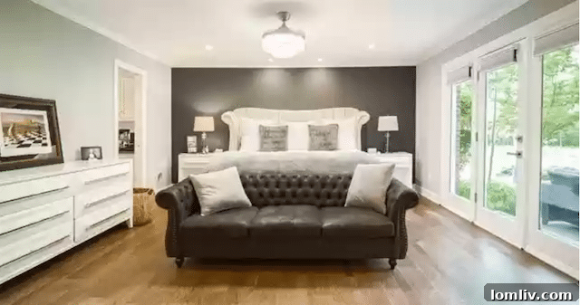 Uncover Lake Highlands: Unexpected Splurges and Smart Steals 7 Tranquil owner's suite in Dallas luxury home with spacious sitting area and glass doors leading to the outdoor oasis