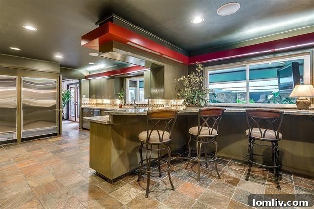Spacious Midcentury Modern kitchen with Sub-Zero appliances and sage cabinets