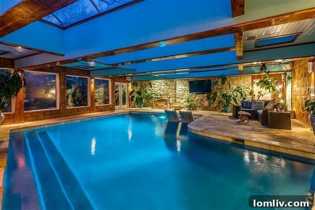Expansive indoor saltwater pool within a skylit garden room
