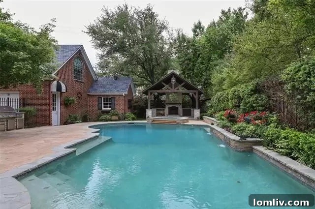 University Park's Georgian Jewel: Your Canvas for Custom Design 7 Resort-style swimming pool with covered patio and outdoor fireplace