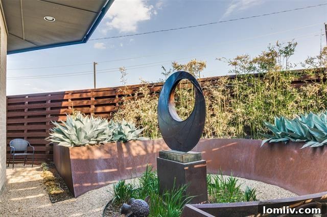 Modern exterior with lush landscaping and outdoor seating area.