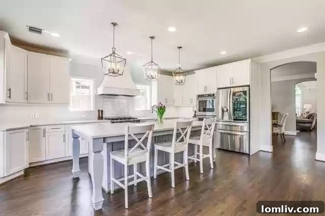 Modern kitchen with high-end appliances, quartz counters, and bright windows.
