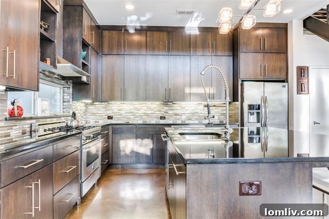 Sleek modern kitchen with large island and ample counter space.