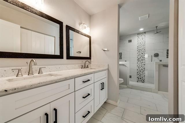 Lochwood Midcentury Modern Awaits Your Masterpiece 6 Elegant Primary Bathroom with Double Sinks and River Rock Shower