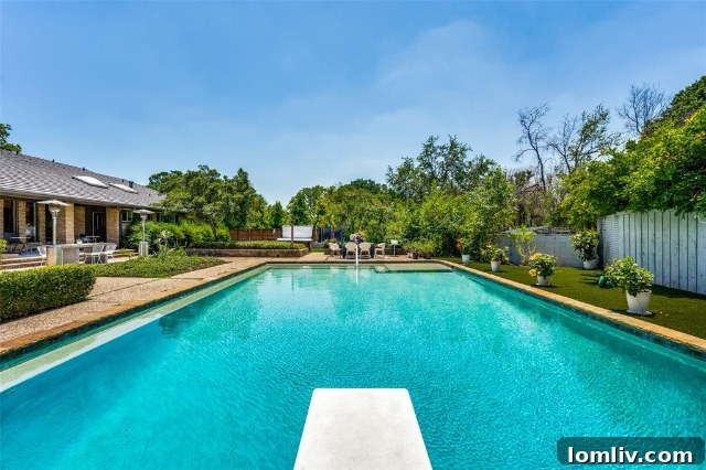 Rear exterior view showcasing the modern ranch architecture and backyard