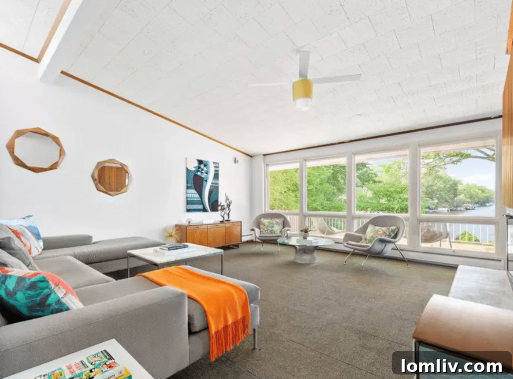 New Jersey's Midcentury Masterpiece Awaits 6 Spacious living area with fireplace and lake views, perfect for relaxation