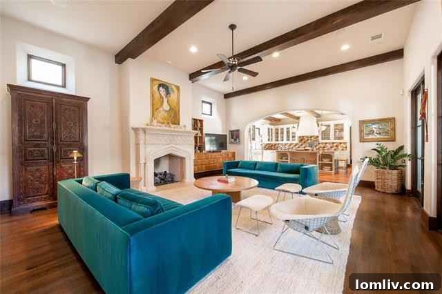 Mediterranean Masterpiece on Bunting Avenue 6 Grand living room with bespoke stone fireplace and clerestory windows