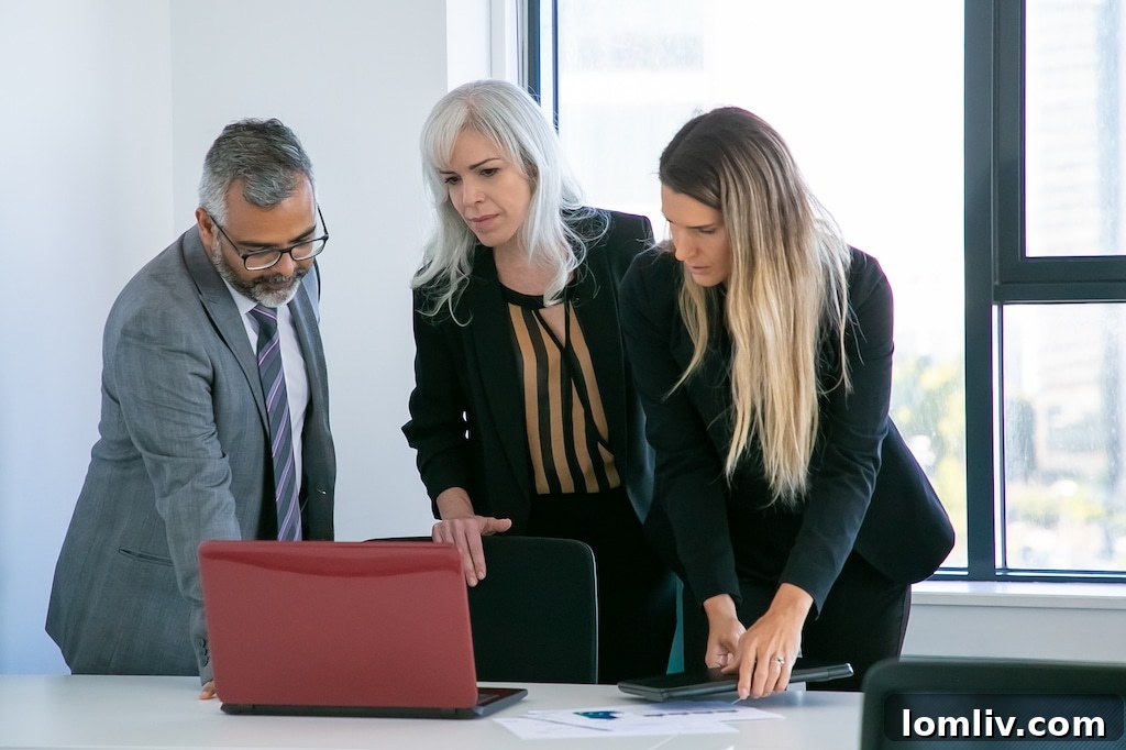 business-group-watching-project-presentation-standing-meeting-table-looking-laptop-display-medium-shot-business-communication-concept