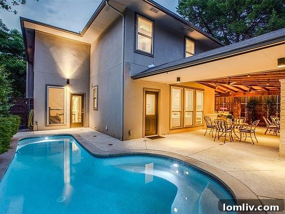 Turfed Play Area Alongside Luxurious Pool and Outdoor Entertaining Space