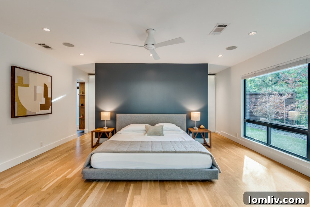 Primary bedroom with large window and scenic view