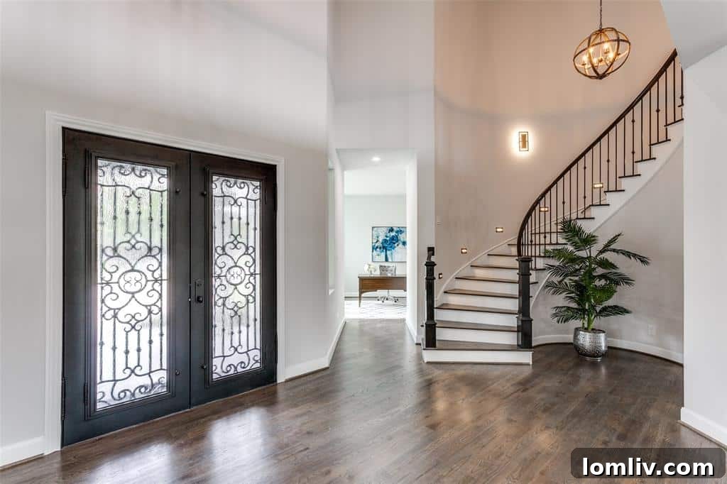 Gourmet chef's kitchen with a large island, premium GE Monogram appliances, and earthy tone tiling in 11041 Lawnhaven Road
