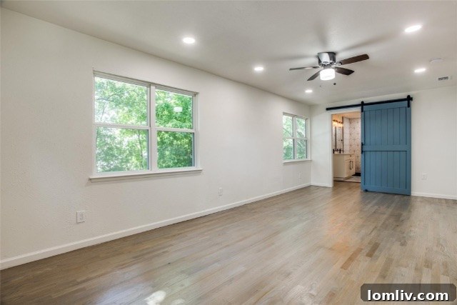 Spacious and serene master bedroom featuring ample natural light and fresh contemporary design