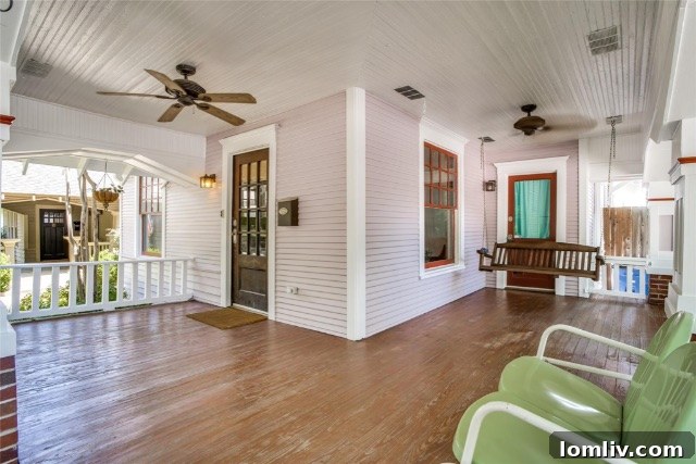 Welcoming front porch of a Winnetka Heights Craftsman, showcasing historic details and well-maintained exterior