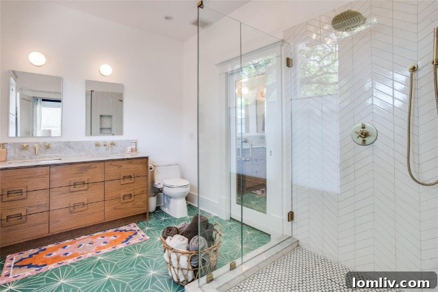 Beautifully renovated primary bathroom featuring a unique reclaimed vanity and elegant tile work in a Winnetka Heights home