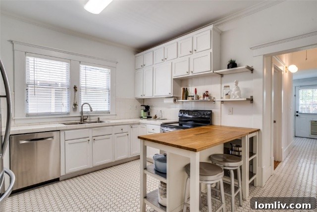 Modern kitchen in a historic Winnetka Heights Craftsman, showcasing preserved cabinetry with modern fronts and elegant backsplash