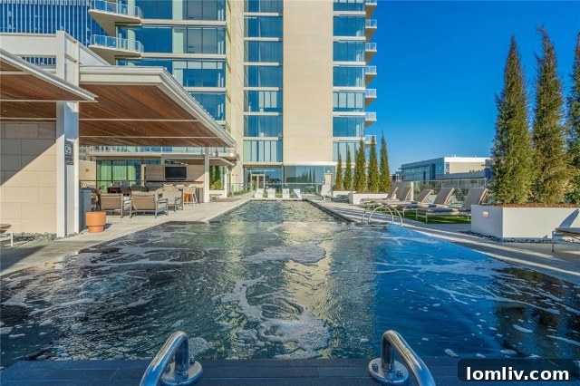 Resort-style swimming pool area at Windrose Tower with lush landscaping