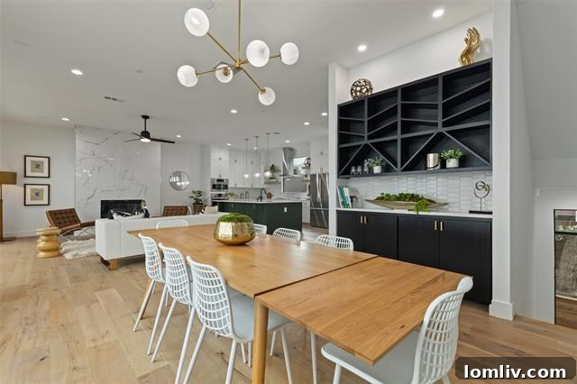 Spacious open-concept living area with modern fireplace and private balcony access