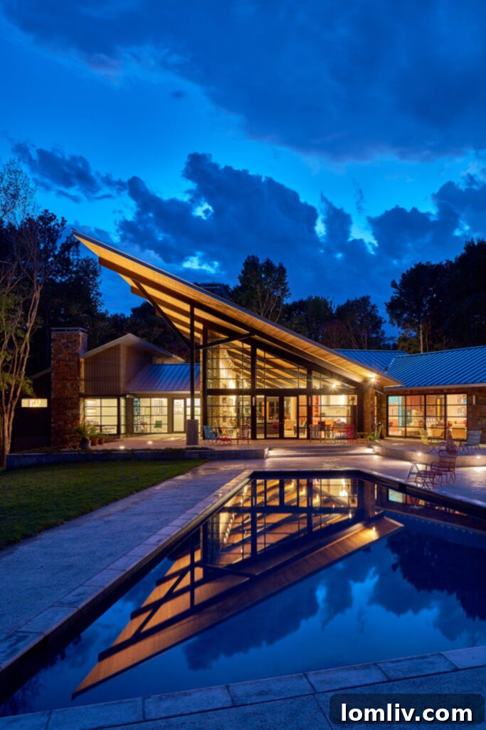 Interior view with large windows connecting Sugar Creek home to its natural surroundings