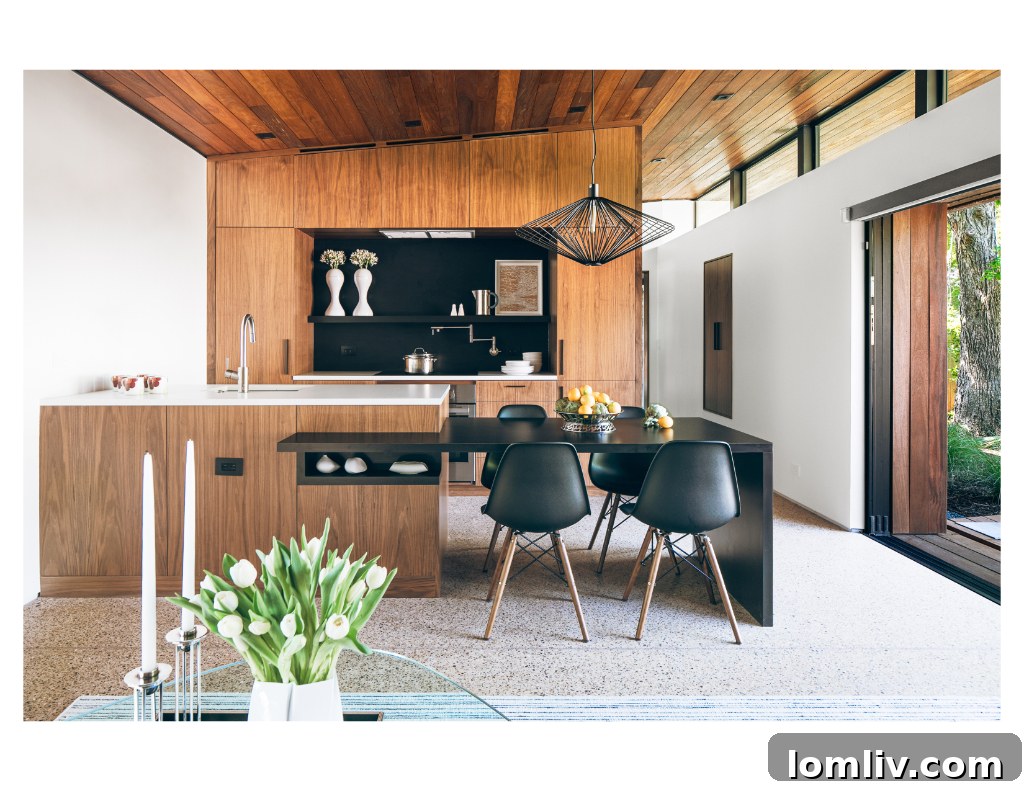 Open-plan living room and kitchen leading to the pool terrace in Five House