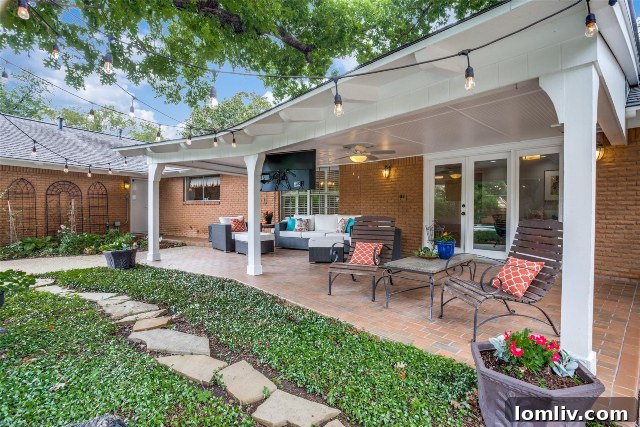 Spacious Covered Patio with Outdoor Seating and Lush Backyard View