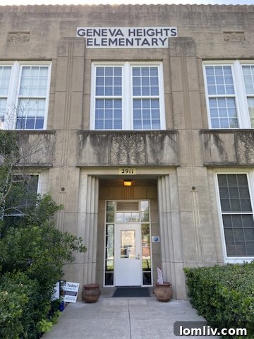 Interior view of a spacious hallway in Geneva Heights Elementary School, highlighting historic elements
