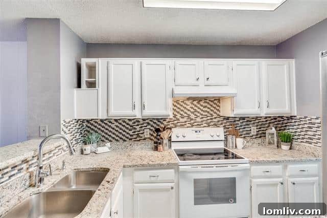 Modern open concept living and dining area with fireplace in Garland townhome