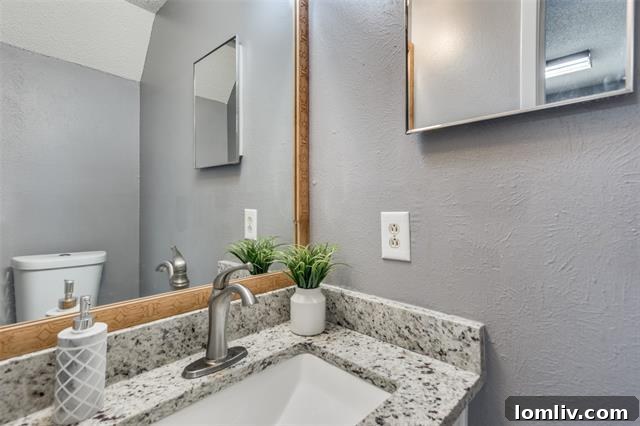 Updated kitchen with granite countertops and breakfast bar in Garland townhome