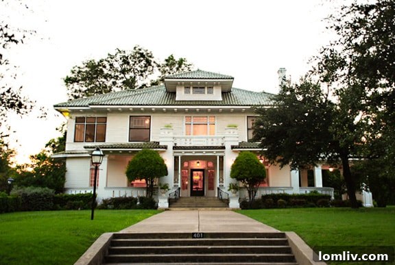 Passport Oak Cliff: Reimagining the Heritage Home Tour 3 The majestic facade of the historic Turner House in Oak Cliff, a prime example of modified Prairie architecture, bathed in soft daylight.