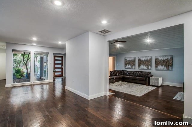 Bright and spacious formal living area with vaulted ceilings and dark wood floors