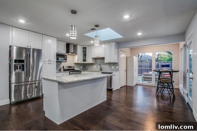 Dining area adjacent to the kitchen, featuring large windows overlooking the patio