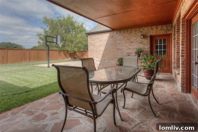 Spacious covered patio and expansive driveway, showcasing ample space for outdoor living and recreation at 6620 Trinity Heights Blvd.