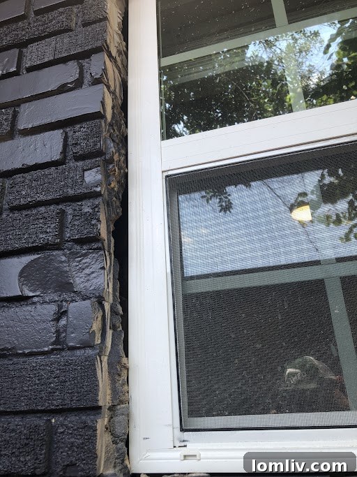 Close-up of a poorly sealed window frame allowing air and water infiltration.