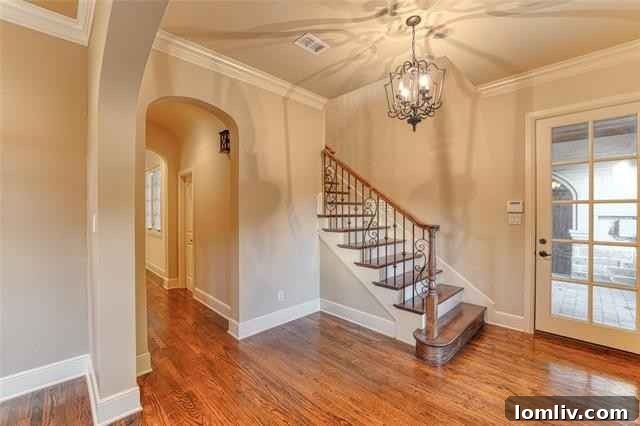 Inviting front entrance of 5604 Collinwood Avenue with elegant iron gates and masonry details