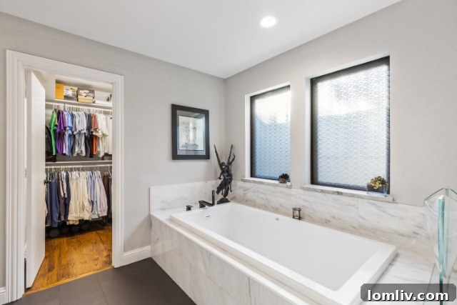 Modern double vanity area with elegant finishes in a Dallas home bathroom