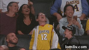 Side view of the ranch house showing its practical amenities: electricity lines, a wooden deck, patio furniture, and a pristine white propane tank against a natural backdrop