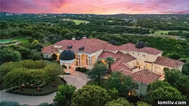 A grand Italian Baroque estate in Escala, Barton Creek, Austin, featuring intricate architecture and lush landscaping.