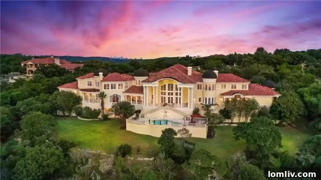 The stunning infinity pool and outdoor entertainment area, offering spectacular views of the golf course and Hill Country.