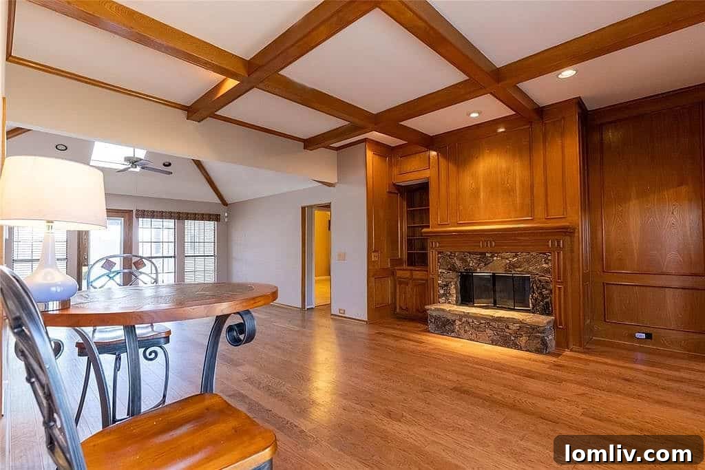 Living room with stone fireplace and box beam ceilings at 4456 Odessa Circle