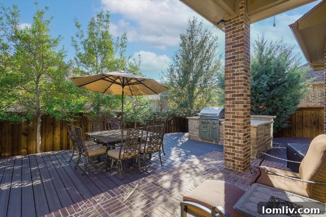 Lush backyard patio with outdoor kitchen and comfortable seating, ideal for entertaining