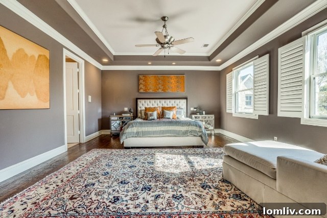 Luxurious primary bedroom with ample natural light and plush carpeting