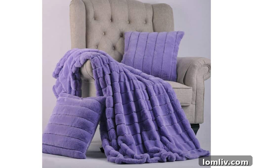 Subtle touches of Very Peri: Purple pillows and throws from Wayfair adding a hint of color to a neutral space