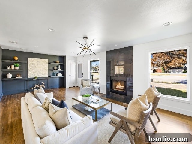 Stunning living room with a feature wall, custom floating shelves, and elegant furnishings at 6440 Royal Lane.